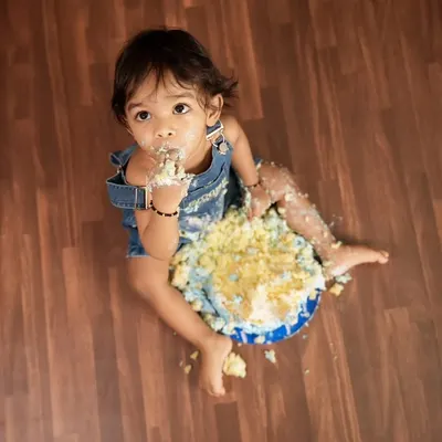 A classic top-down view of a baby enjoying a cake smash session. This is all about letting them have fun and getting messy for some unforgettable photos.