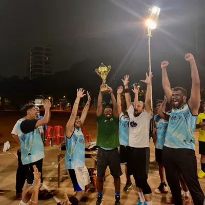 That championship feeling. The men's division winners celebrating their hard-fought victory with the trophy held high.