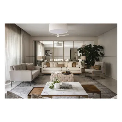 This living area embodies modern simplicity and warmth. We used a wall of floor-to-ceiling mirrors to make the space feel larger and brighter, reflecting the neutral tones of the plush, comfortable sofas.