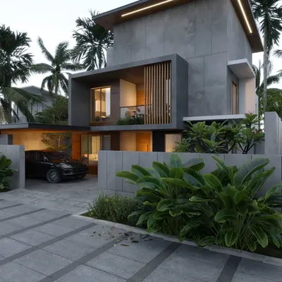 A residence in Palakad featuring a powerful concrete form with a recessed wooden screen. The design uses integrated lighting along the roofline to highlight its clean, geometric shape.