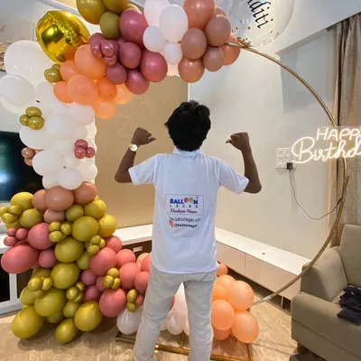 Our team member proudly showcasing a finished birthday ring garland. We love seeing our hard work come together to create a beautiful celebration piece.