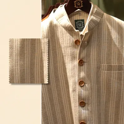 This is not just fabric; it’s your narrative. A close-up of a striped linen jacket with a swatch, showing how every texture tells a story without a single word.