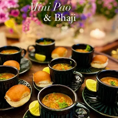 I bring you delicacies from around the world, and sometimes, from our own streets with a twist. This is my Mini Pao & Bhaji, served elegantly in small cups and saucers. It's a bite-sized version of the Mumbai classic, perfect for sophisticated snacking.