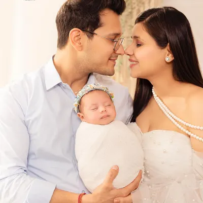 A peaceful moment between new parents and their sleeping baby. I specialize in creating serene and beautiful portraits that capture the love of a new family.