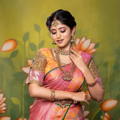 A beautiful shot from a portfolio session. This look features a colorful Kanjivaram saree, traditional temple jewellery, and a soft, romantic makeup application with a focus on pink tones.