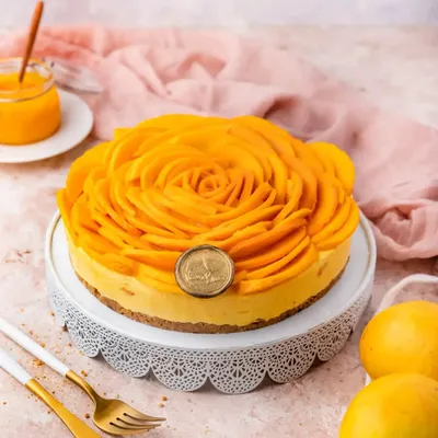 A preview of our mango collection. This is our Mango Cheesecake, featuring a beautiful rosette of fresh mango slices on top of a creamy, homemade aamras-infused filling.