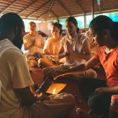 A student participates in a lamp lighting ceremony, a beautiful ritual symbolizing the dispelling of darkness and the welcoming of knowledge. Each flame represents the inner light we seek to awaken through our practice.