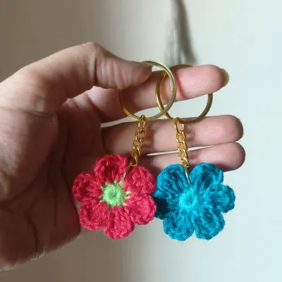 Our floral keychains are a small pop of color for your everyday essentials. Here are two examples, one in bright pink and the other in a lovely turquoise.