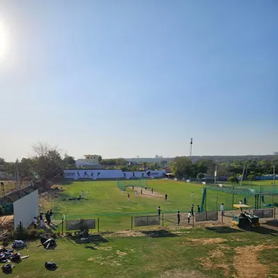 A wide-angle view of our ground on a bright, sunny day. This is the canvas where players work on their skills, from batting drills to full-fledged practice matches.