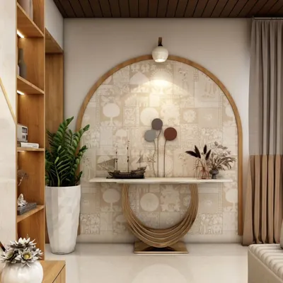 A beautifully designed foyer area featuring a statement console table with a unique circular base. The arched niche with patterned wallpaper and a single pendant light creates an elegant and welcoming first impression.