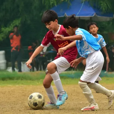 A player shields the ball from an opponent during a competitive match at the RSA tournament. This demonstrates the strength and ball control we instill in our players.