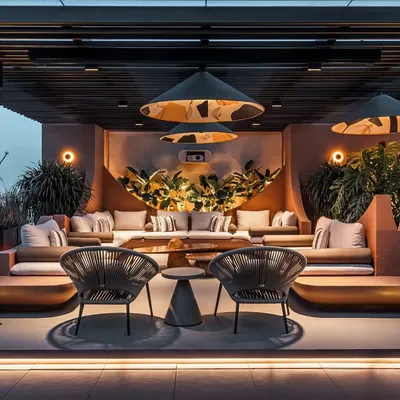 The terrace at night, transformed into a magical garden with custom oversized pendant lights. The space is designed for everything from lively conversations to cozy movie nights, with an integrated projector screen.