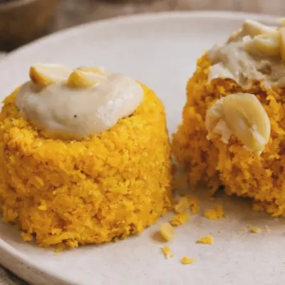 A healthy twist on a classic dessert. This is a raw-style gajar halwa, made with fresh ingredients to keep the natural crunch and sweetness of the carrots, topped with a creamy nut-based sauce.