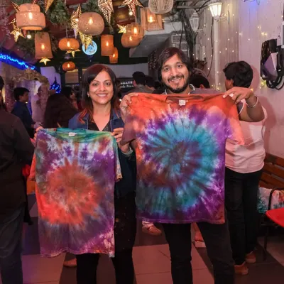 A happy couple shows off the vibrant, matching tie-dye shirts they created in one of my fun and colorful craft workshops.