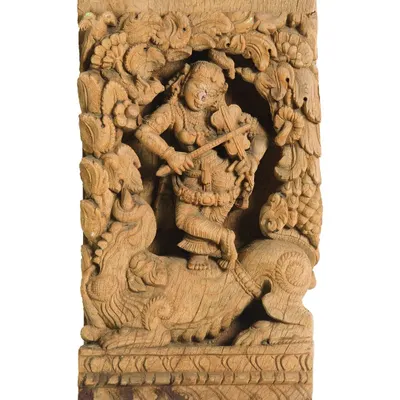 This restored wooden panel from a temple chariot shows a musician atop a mythical creature. The project involved stabilizing the century-old wood, cleaning its surfaces, and preserving the incredible detail of the original carving.