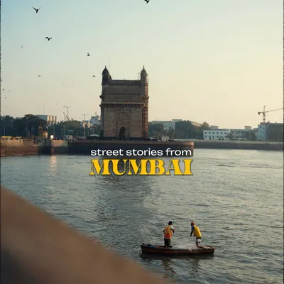 Titled "Street Stories from Mumbai," this image of two fishermen in a small boat in front of the Gateway of India serves as a perfect introduction. It encapsulates the blend of daily life and iconic backdrops that defines the city.