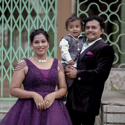 A beautiful family portrait that truly shows that living together is heaven. The woman wears a stunning purple gown with intricate beading on the shoulders, perfect for a memorable family photoshoot.