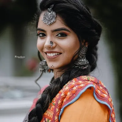 A beautiful portrait from a themed shoot, showcasing a model in a traditional-meets-modern outfit with striking silver jewelry.