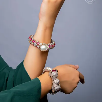 This pair of kadas from our Luxury Collection is crafted in 18k gold with rare Burmese rubies. One features delicate floral motifs, while the other pays homage to Indian royalty with intricately designed elephant heads.