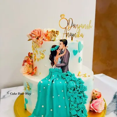 Two hearts, one cake, infinite memories. This handcrafted engagement cake features a beautiful couple illustration and a 3D floral dress effect.