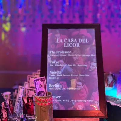 A close-up of the custom 'La Casa Del Licor' menu I created for a Money Heist themed sangeet, with cocktails named after characters like 'The Professor' and 'Tokyo'.