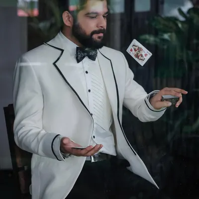 An action shot from Kshitish Date's photoshoot, where the crisp white tuxedo allows for dynamic and engaging portraits.
