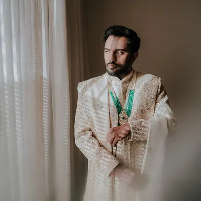 A moment of quiet anticipation for the groom. I captured this portrait of Sourav by the window, the soft light highlighting the intricate details of his sherwani and his contemplative expression.