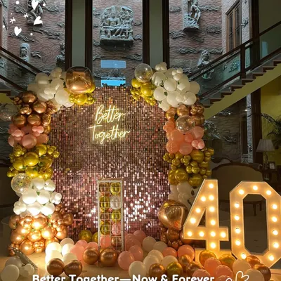 Better together, now and forever. This grand setup for a 40th anniversary featured a stunning rose gold sequin wall, a lush balloon arch, and marquee numbers to celebrate four decades of love.