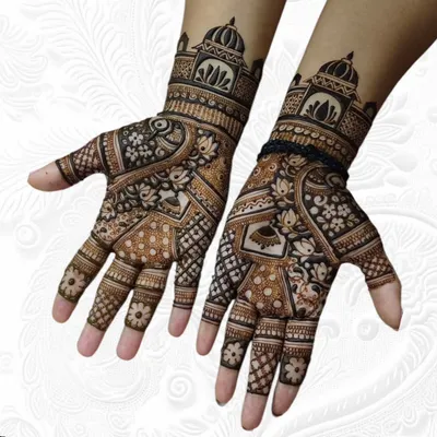 A classic Teej festival design featuring palace architecture on the wrists and a mix of lotus and peacock motifs on the palms.