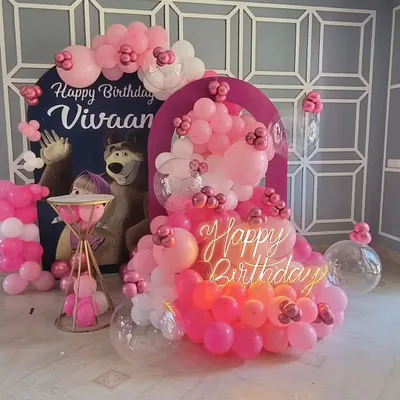 A fun Masha and the Bear theme featuring character cutouts against a custom arch backdrop. The pink balloon cascade, clear bubble balloons, and a 'Happy Birthday' neon sign make this a delightful setup for a young child's party.