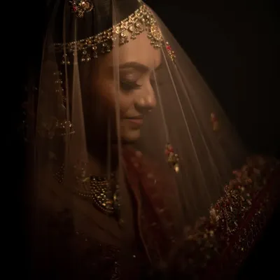 "In a world full of trends, she wanted to be a classic." A moody, artistic portrait of a bride under her veil, creating a timeless and mysterious look.