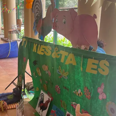 My portable puppet stage all set up for a farm animal adventure. The colorful banner and character cutouts immediately set a fun and inviting tone for the show.