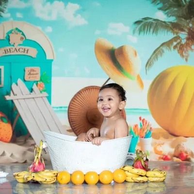 Pure happiness in a tub! This beach-themed milk bath shoot is full of smiles, with bananas and oranges adding a tropical touch.