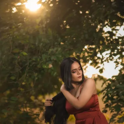 A shot from a golden hour session in a park. I love how the setting sun filters through the trees, creating a natural, warm light that's perfect for dreamy portraits.