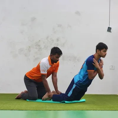 Our trainers provide support and guidance during every exercise. Here, a player performs a core-strengthening exercise with the assistance of a fitness coach.