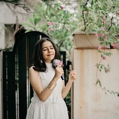 A professional shot from a performance, microphone in hand. This captures the joy and focus I bring to every live event, ensuring a memorable experience for you and your guests.