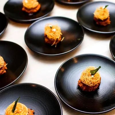 The key to an unforgettable event is personalization. Here, our lamb shikampuri kebabs are lined up, ready to be served at a private gathering. We bring our inventive cuisine to you.