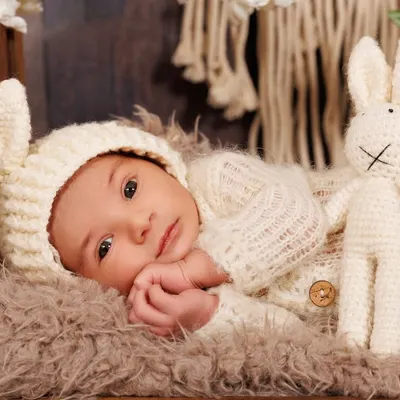 Capturing the peaceful, alert moments of a newborn. This little one, dressed in a cozy knit bunny outfit, looked right at my camera.