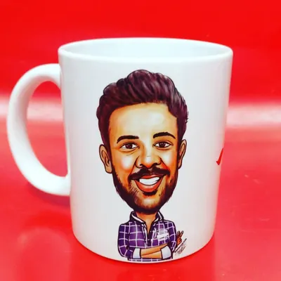 A close-up of a finished caricature mug against a bright red background. This shows how crisp and vibrant the final printed product looks.