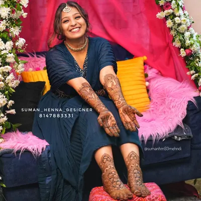 The joy on a bride's face is everything. This is why I pour my heart into every design. Here you can see a complete bridal look, with detailed henna on both the hands and feet, telling her unique wedding story with peacocks and doli motifs.