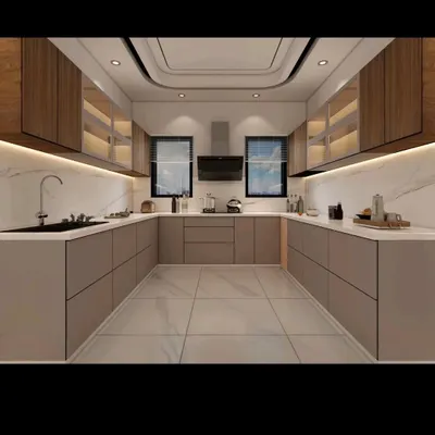 A spacious and elegant U-shaped modular kitchen I designed. It features handleless cabinets for a sleek look, a white marble backsplash, and integrated lighting under the overhead units to illuminate the countertop.