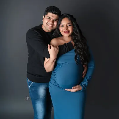A classic and happy couple's maternity portrait. Including your partner is a wonderful way to capture the love and support that surrounds your growing family.