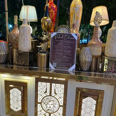 An elegant buffet counter featuring our detailed menu and decorative lamps. I ensure every detail contributes to a luxurious ambiance for your special day.
