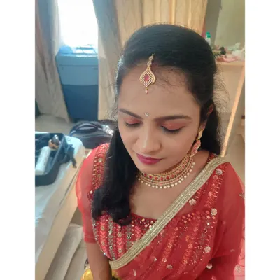 This is an example of a simple and elegant makeup look. The focus is on clean skin, soft pink eyeshadow, and a matching lip, perfect for a daytime event or for someone who prefers minimal makeup.