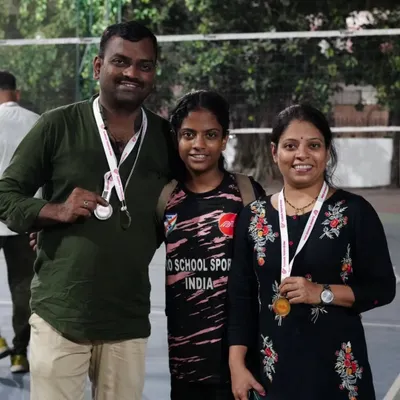 A proud moment for one of our athletes and her parents after a successful tournament. This is what our community is all about: sharing in the joy of achievement and recognizing the hard work of our players.