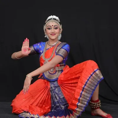 My student Aditi in her costume for 'Bho Shambho'. The vibrant orange and blue silk, paired with traditional temple jewelry, was chosen to reflect the devotional energy of this powerful piece dedicated to Lord Shiva.