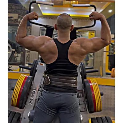 A well-developed back is the sign of true strength. This double biceps pose shows the result of heavy rows, pull-ups, and deadlifts.