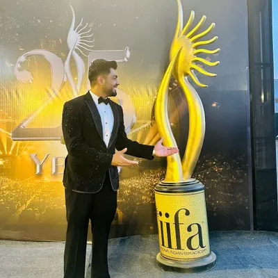 A proud moment, standing next to the IIFA trophy in a custom Zenmen tuxedo. This black suit with subtle crystal work was designed to shine on the red carpet.