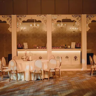 A wide view of the magnificent palace courtyard set we designed. The tall arches and custom bar create a sense of grandeur, turning a simple hall into a space fit for royalty.