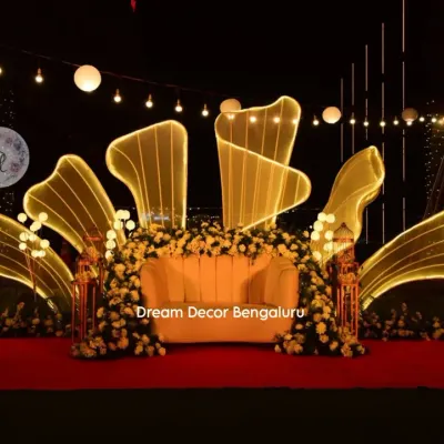 This is one of our signature stage designs, perfect for making a grand statement. We created this stunning backdrop with custom-lit abstract shapes and lush white florals for an anniversary party.